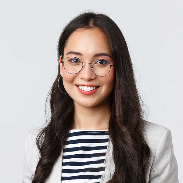 A woman with long hair and glasses smiling for the camera.