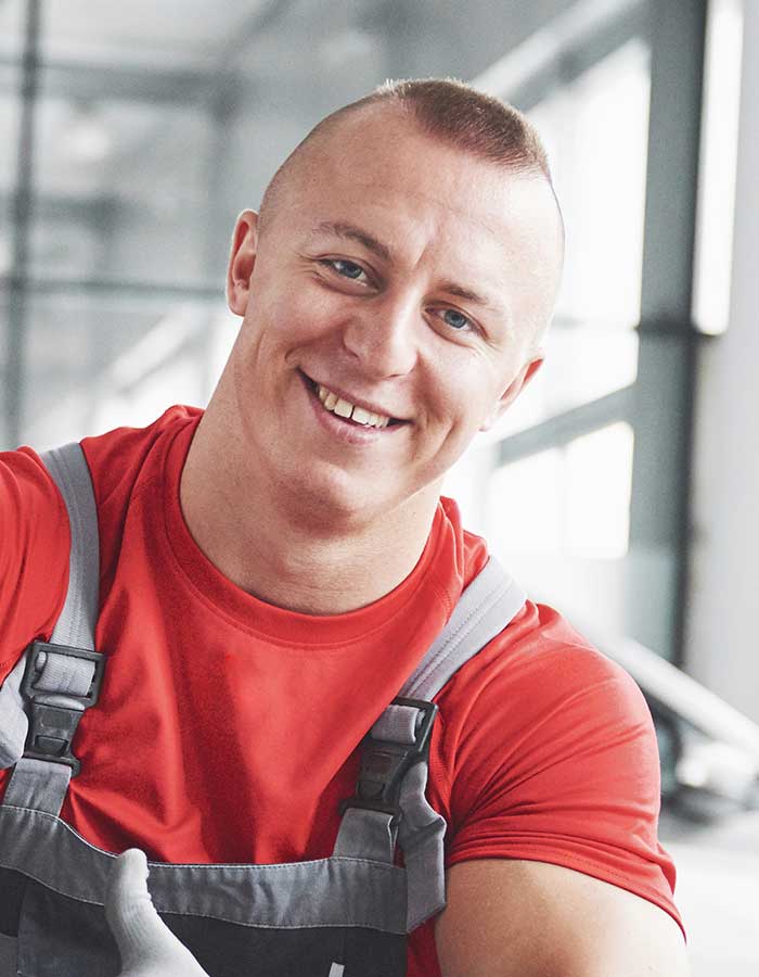 A man in red shirt smiling for the camera.