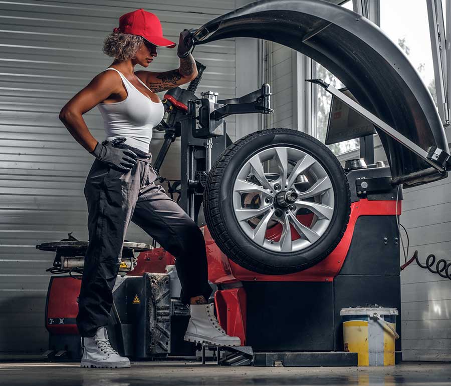 A woman standing in front of an open tire.