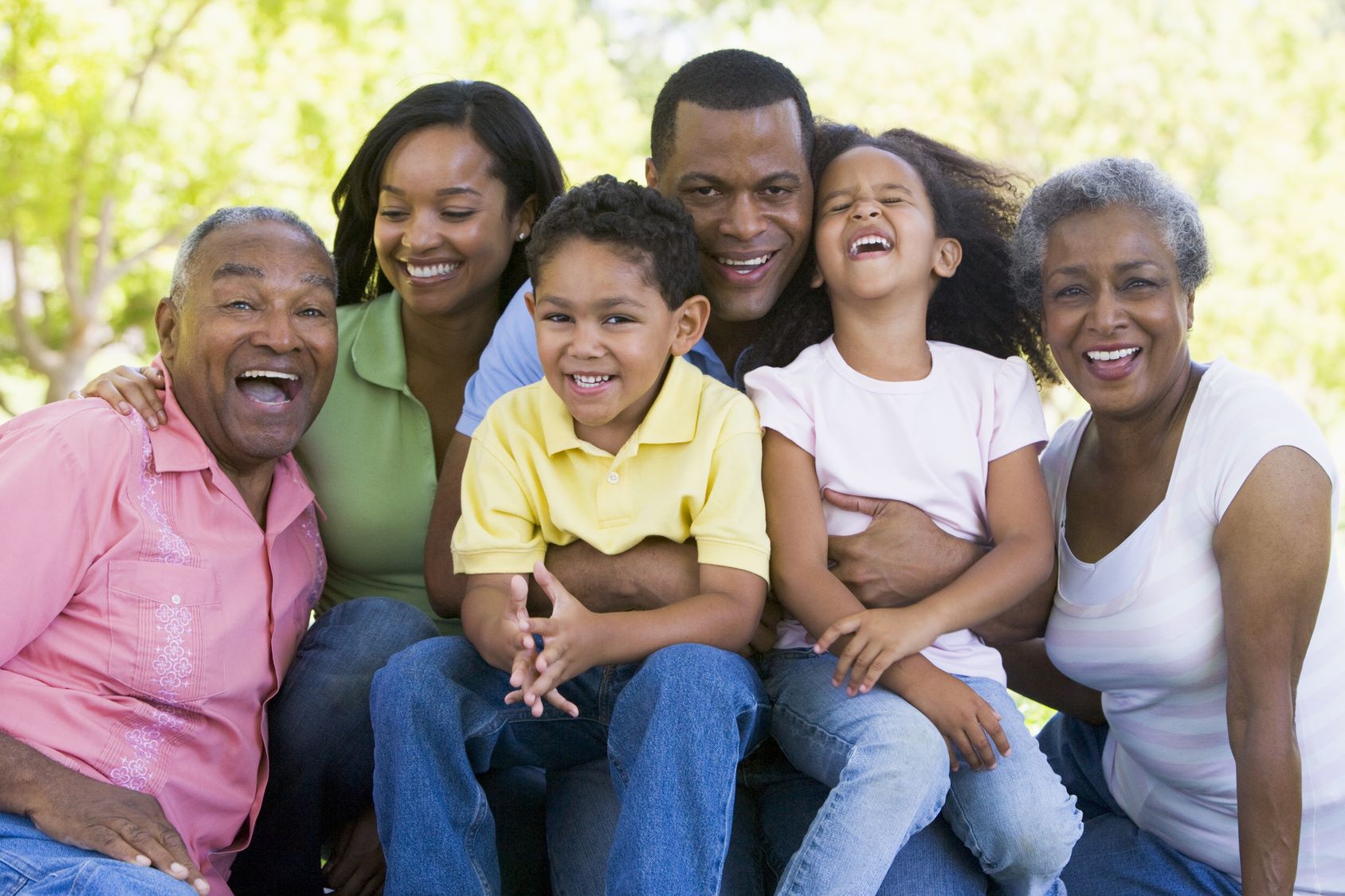 A group of people sitting on top of each other.