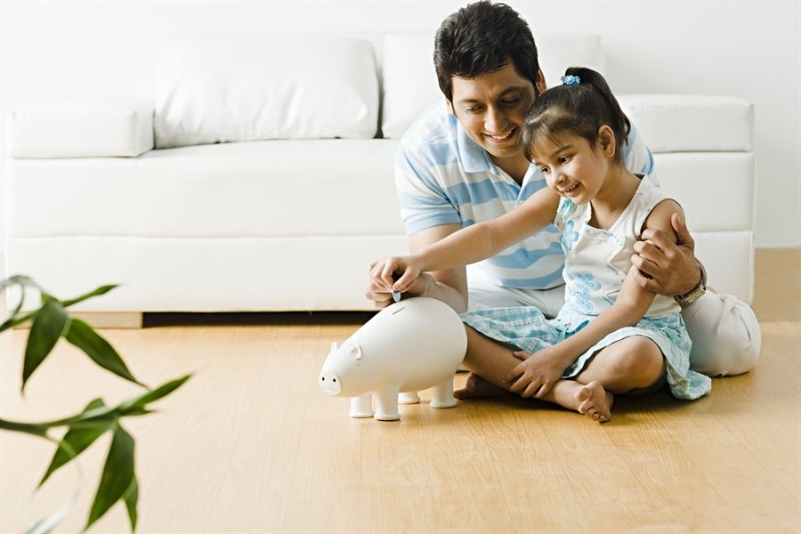 A man and child playing with an electric device.